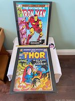 Overall view showing both framed posters on table