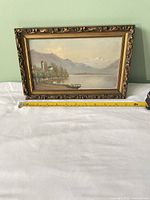 Front view showing entire framed painting and measuring tape for scale