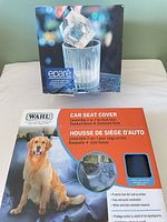 Front view of both boxed items: eparé ice cube tray and Wahl dog car seat cover
