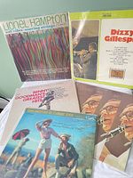 Group shot of six jazz/big-band LPs in sleeves