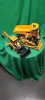 All three CAT vehicles grouped: dump truck, bulldozer, excavator