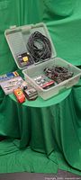 Plastic bin with carburetor, kit, freeze plugs, cable, gauge and manual