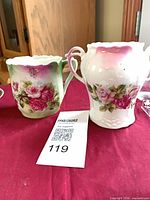 Mustache cup and creamer front view showing rose decoration