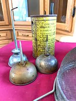 Three oil cans and yellow printed tin