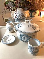 Entire set displayed showing basin, pitcher, chamber pot with lid, mug, soap dish, small vase
