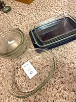 Group shot showing round casserole, clear rectangular dish, and dark blue dish