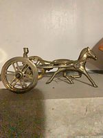 Full side view of brass horse and chariot figurine