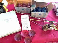 Overview of boxed candles and snuffers on table