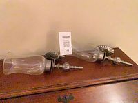 Both matching sconces side by side on furniture