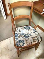 Front view of maple chair showing seat upholstery and curved backrest