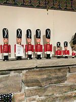 All nine wooden Danish guard soldiers lined on stone mantel