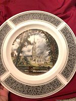 Front of plate showing cathedral scene and scroll border
