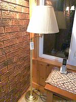 Full view of floor lamp showing base, pole and shade