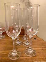 Six Lenox Moonspun wine glasses on wooden surface