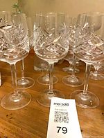 Group of six cut crystal wine glasses on table