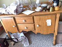 Front view of maple sideboard with drawers and doors
