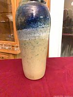 Full view of tall pottery vase front