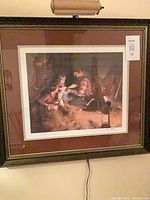 Full view of framed signed print with picture light