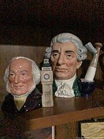 Two character jugs on a shelf