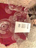 Overhead view of all eight etched floral stemware glasses