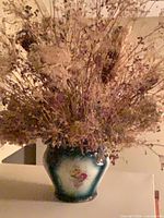 Full view of porcelain vase and dried flowers