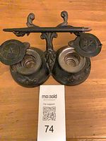 Top view showing glass liners, hinged lids open and pen on rest