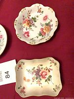 Top view of two Royal Crown Derby Posies dishes showing floral pattern and scalloped edges