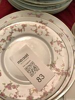 Close-up of dinner plate showing floral pattern and gold rim