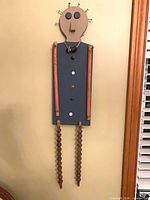 Front view of abstract person wall sculpture hanging on wall