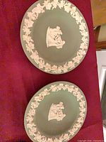Two sage green Wedgwood jasperware plates front view