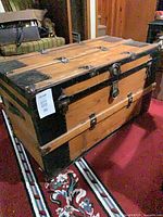 Closed view of antique wooden trunk on carpet