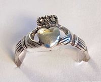 Front view showing crowned heart and hands motif