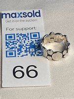 Ring standing beside MaxSold lot card