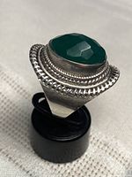 Ring angled on stand showing stone and bezel detail