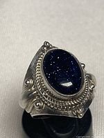 Front view of sterling silver ring with blue goldstone cabochon