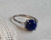 Ring angled view showing lapis lazuli cabochon and prong setting
