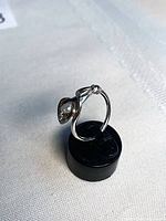 Front-left angle showing lily design and pearl