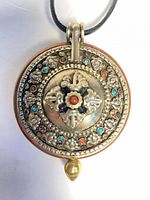 Front view showing floral motif, cabochon accents, gold-tone drop finial