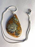 Necklace laid flat showing pendant front, chain, and clasp