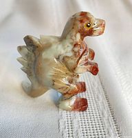 Front side of soapstone stegosaurus figurine