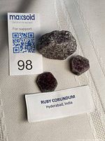 Three raw ruby corundum pieces with lot tag
