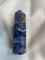 Front view of sodalite point showing color and veining