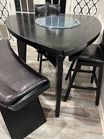 Overall view of triangular table, glass lazy Susan, bench and chair