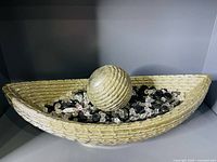 Boat-shaped bowl containing crystals and sphere