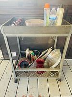 Front view of two-tier metal rolling cart on casters