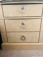 Close-up of drawer fronts and ring pulls
