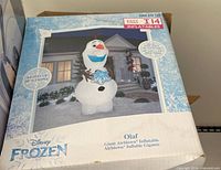 Box front showing Disney Frozen Olaf giant airblown inflatable, highlighting product image and features
