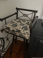 Front view of bar stool showing frame, arms, backrest and cushion