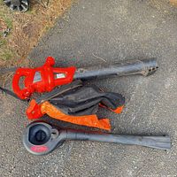 Main unit attached to blower tube, collection bag, separate vacuum housing and tube visible