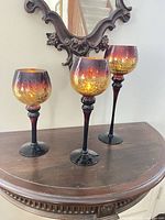 Three crackle glass goblet candle holders on table